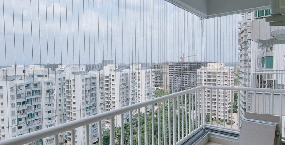 Residential building elevation with balcony railing and safety grills by VaradShree
